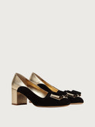 Black suede Salvatore Ferragamo pump with gold bow hardware, front angle