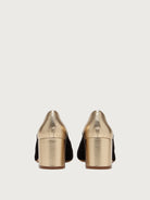 Black suede Salvatore Ferragamo pump showing metallic gold toe cap detail