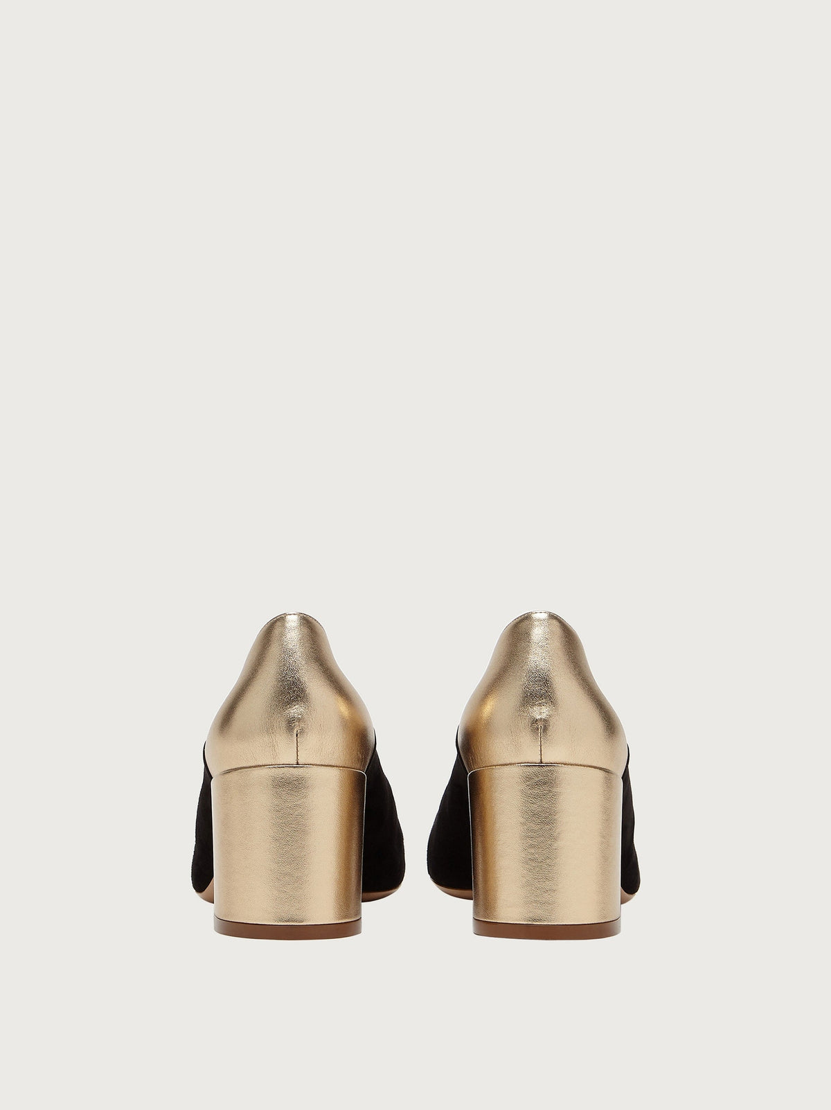 Black suede Salvatore Ferragamo pump showing metallic gold toe cap detail