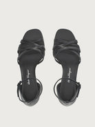 Black Salvatore Ferragamo sandals with buckle ankle strap, side view