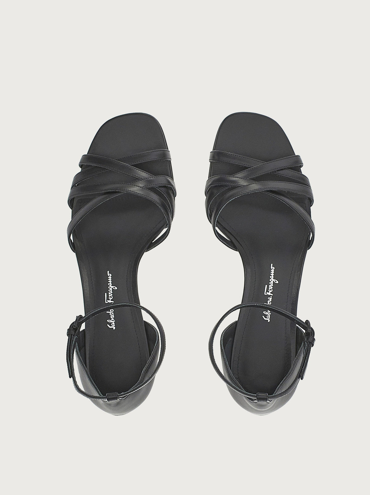 Black Salvatore Ferragamo sandals with buckle ankle strap, side view