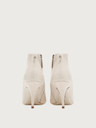 Salvatore Ferragamo white leather bootie showing Gancini hardware pull-tab, back view