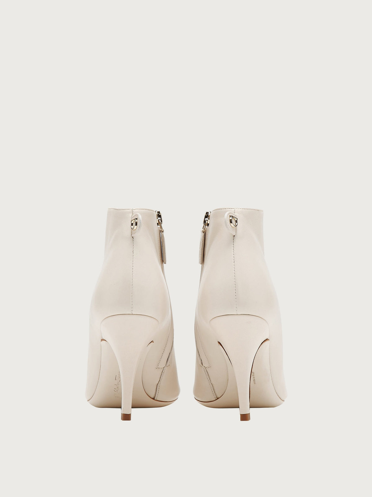 Salvatore Ferragamo white leather bootie showing Gancini hardware pull-tab, back view