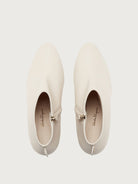 White pointed toe ankle bootie by Salvatore Ferragamo, three-quarter view