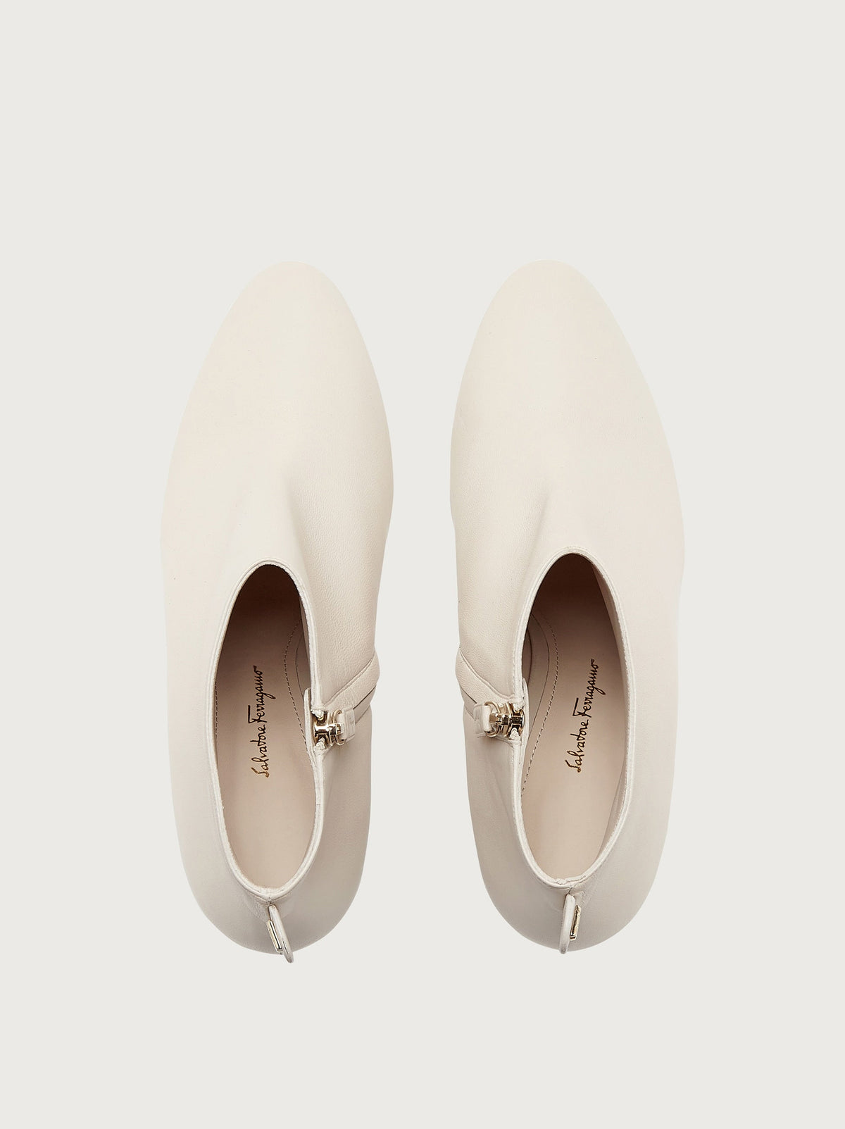 White pointed toe ankle bootie by Salvatore Ferragamo, three-quarter view