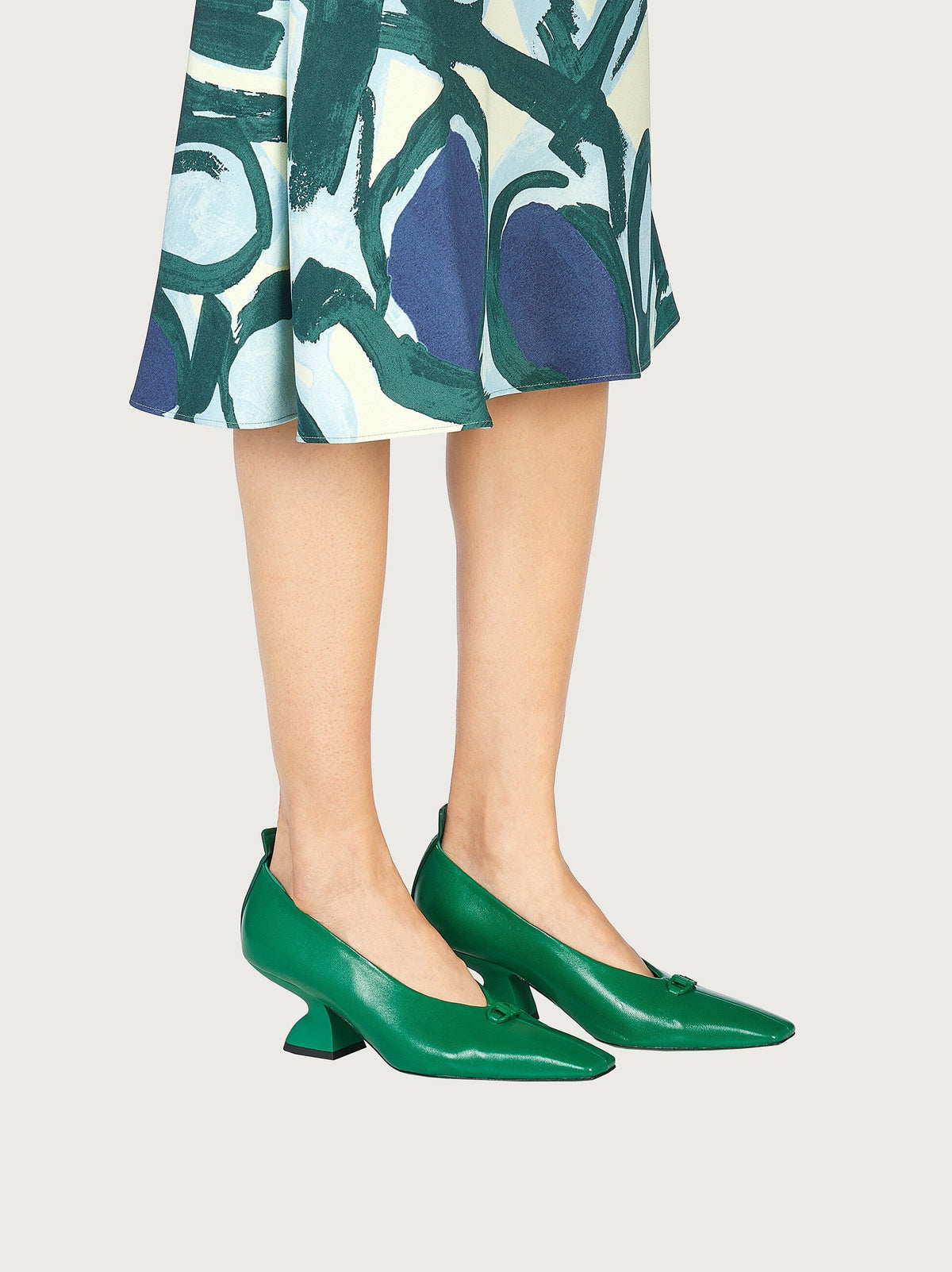 Green leather pump by Ferragamo with buckle vamp detail, close-up