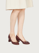 Salvatore Ferragamo bordeaux leather pump showing Gancini hardware detail at toe