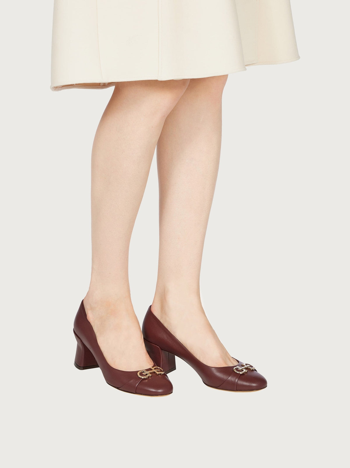 Salvatore Ferragamo bordeaux leather pump showing Gancini hardware detail at toe
