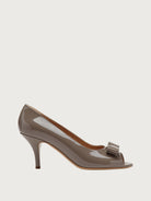 Taupe-grey Salvatore Ferragamo peep-toe pump with bow hardware, side view