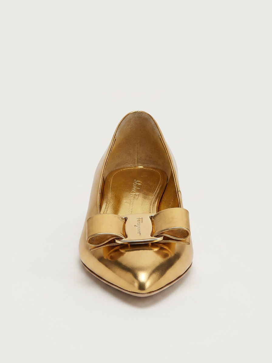 Metallic gold Salvatore Ferragamo ballet flat with bow detail, side view
