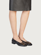 Black Salvatore Ferragamo Myrna ballet flat showing oversized buckle detail
