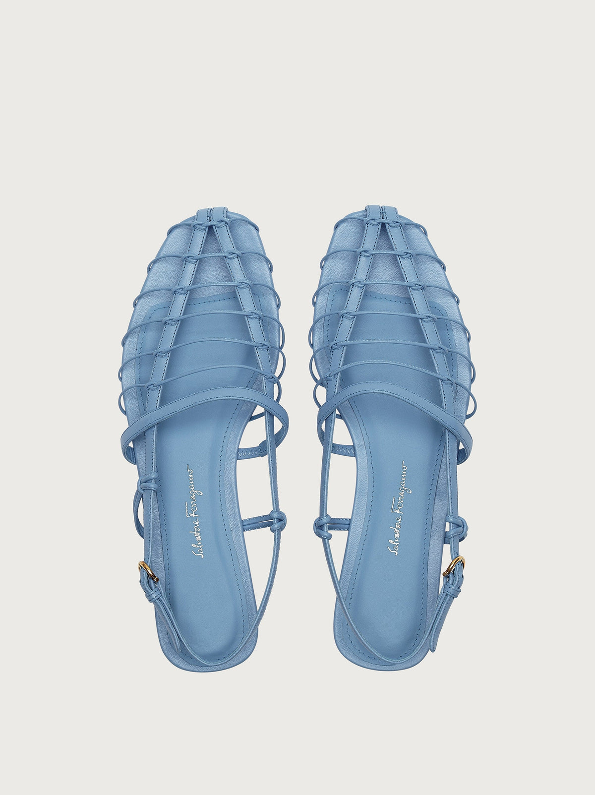 Light blue flat sandal by Salvatore Ferragamo, rear view with ankle strap