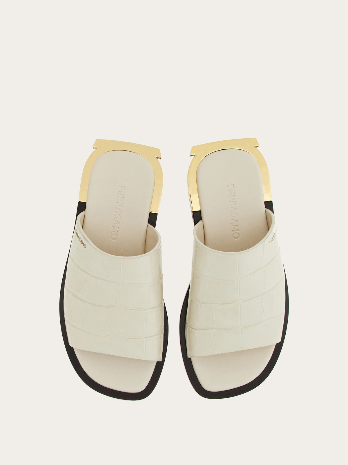 White Salvatore Ferragamo Aline C slide sandal, side profile showing gold-tone heel hardware