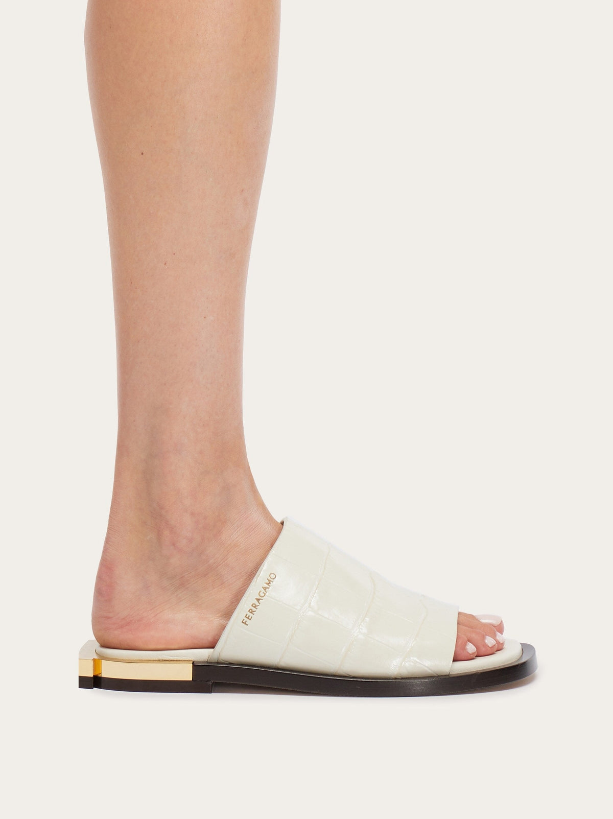 White leather slide sandal by Salvatore Ferragamo, top view showing open-toe design