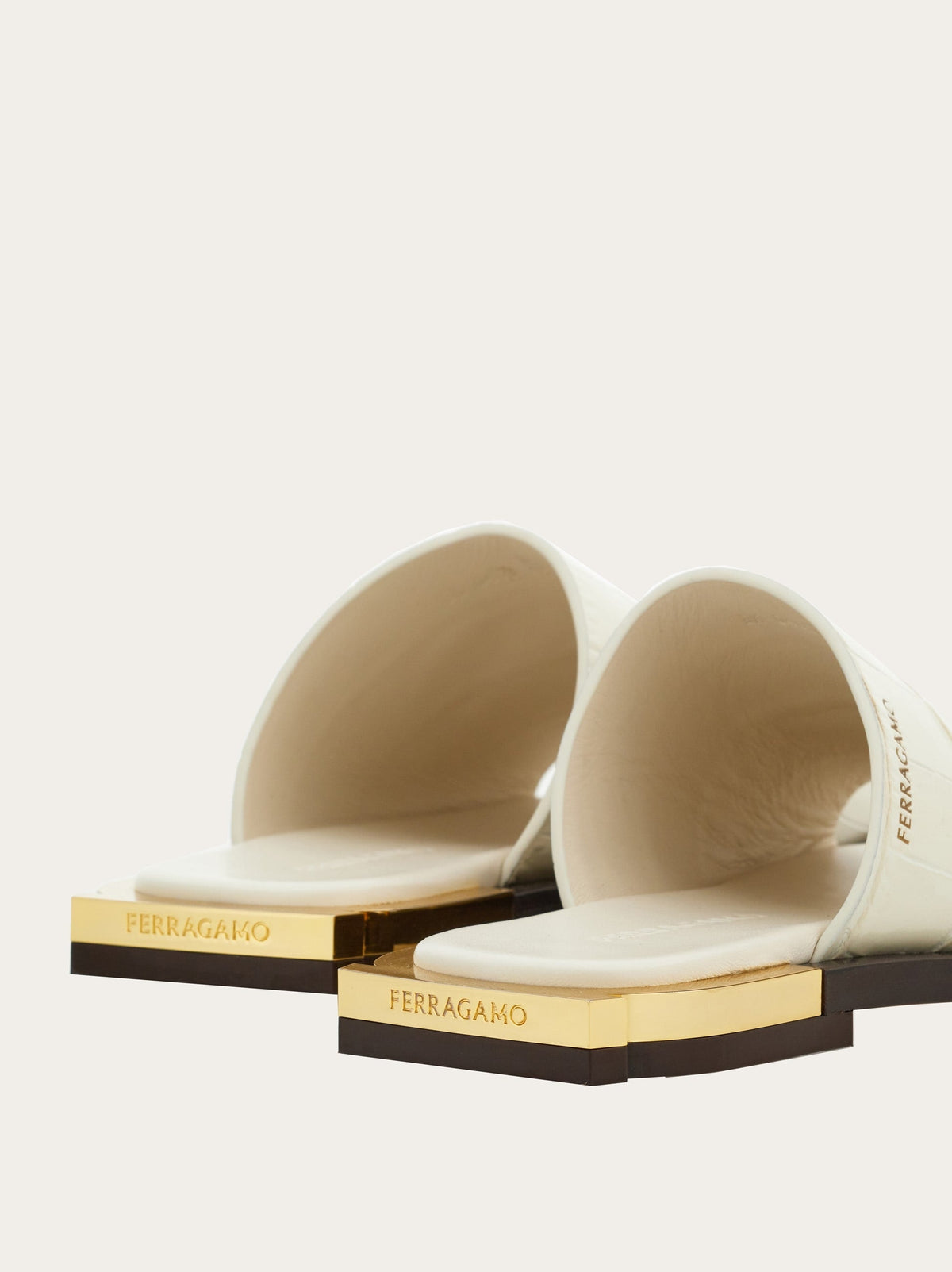 Salvatore Ferragamo white slide sandal, rear view highlighting gold hardware detail
