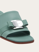 Light olive green Salvatore Ferragamo Vara Plate slides, close-up of squared buckle