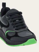 Black Salvatore Ferragamo Cosimina sneaker showing lace-up fastening detail