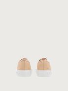 Light pink Ferragamo sneaker rear view with embossed Gancini motif
