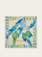 Cream Salvatore Ferragamo scarf with blue and green parrot print, flat lay view