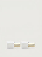 Silver and gold-tone metal cufflinks with ridged bar design by Salvatore Ferragamo, front view