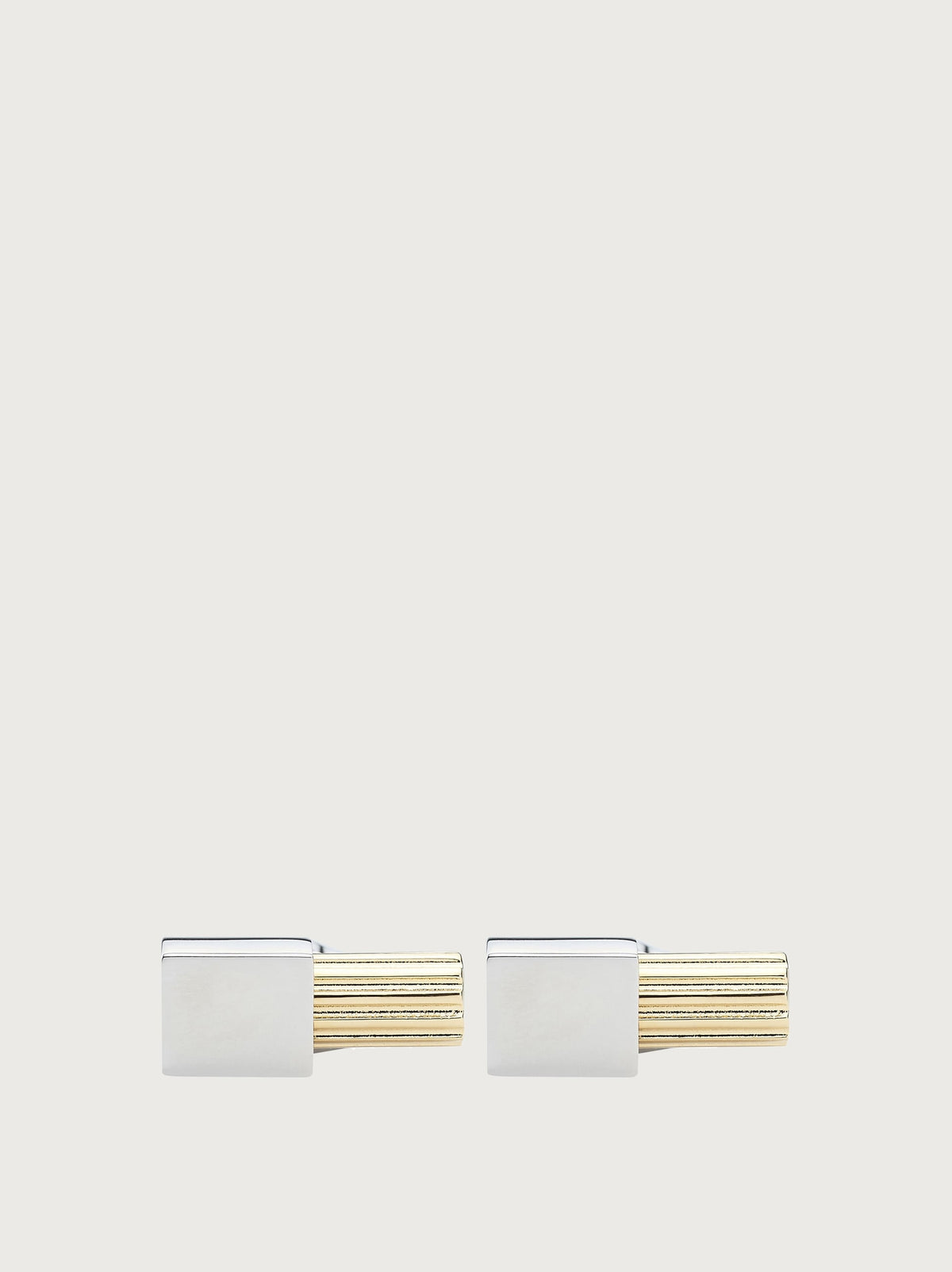 Silver and gold-tone Salvatore Ferragamo cufflinks, side profile view