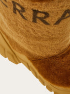 Medium brown shearling Delphi boot by Salvatore Ferragamo, top view with signature