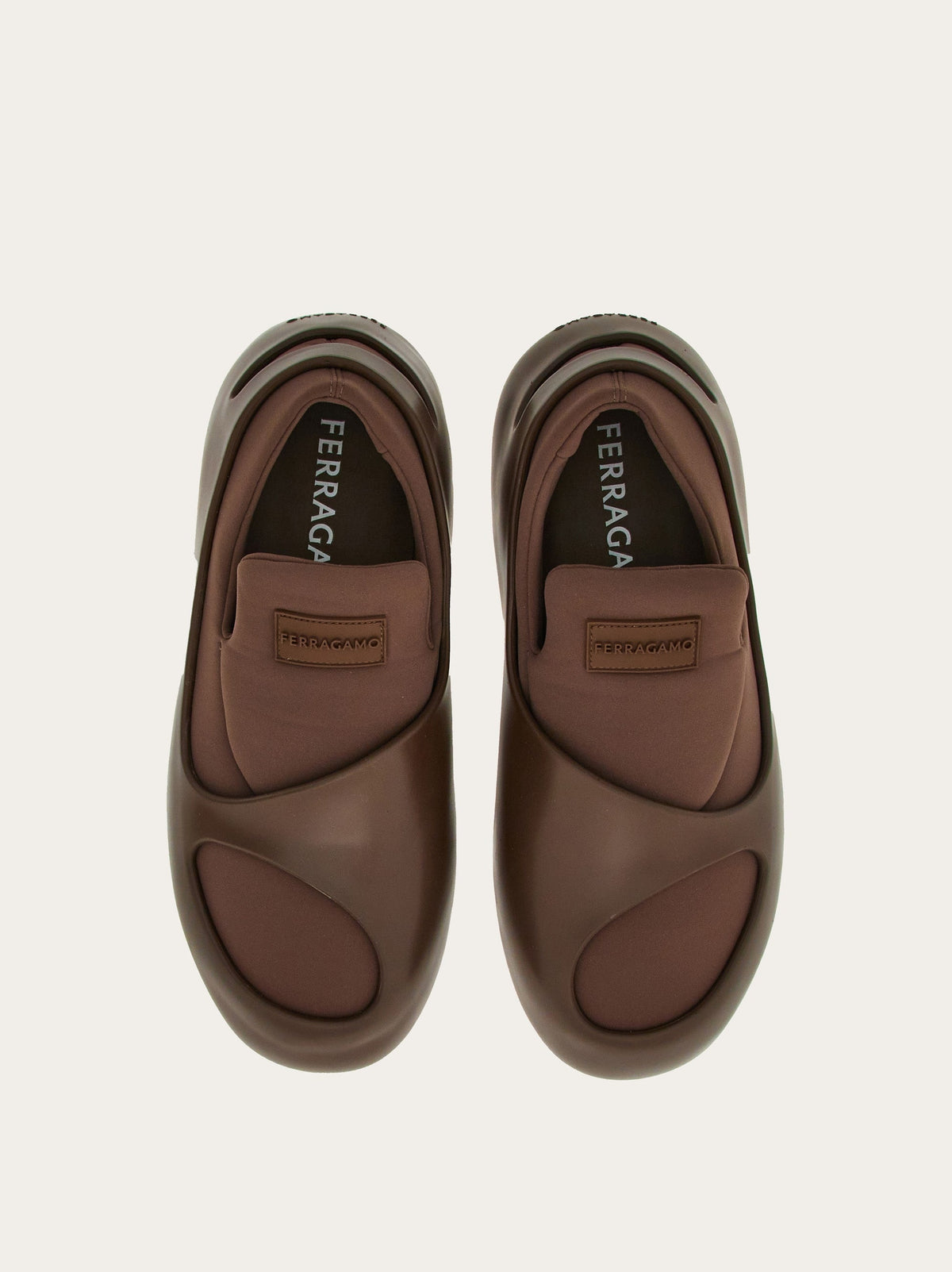 Medium brown Salvatore Ferragamo hybrid slip-ons showing rounded cutout detail, angled view