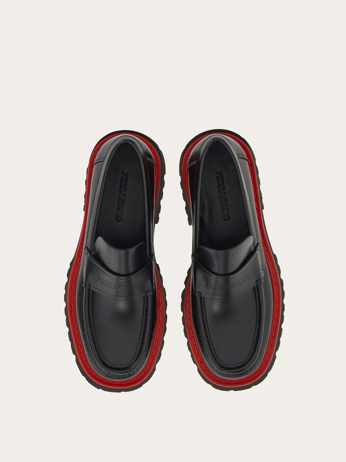 Black Salvatore Ferragamo Fergal loafer showing red midsole detail, angled view
