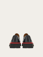 Black Salvatore Ferragamo Fergal loafer top view showing debossed logo strap