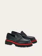 Black Salvatore Ferragamo Fergal loafer sole view with red midsole layer