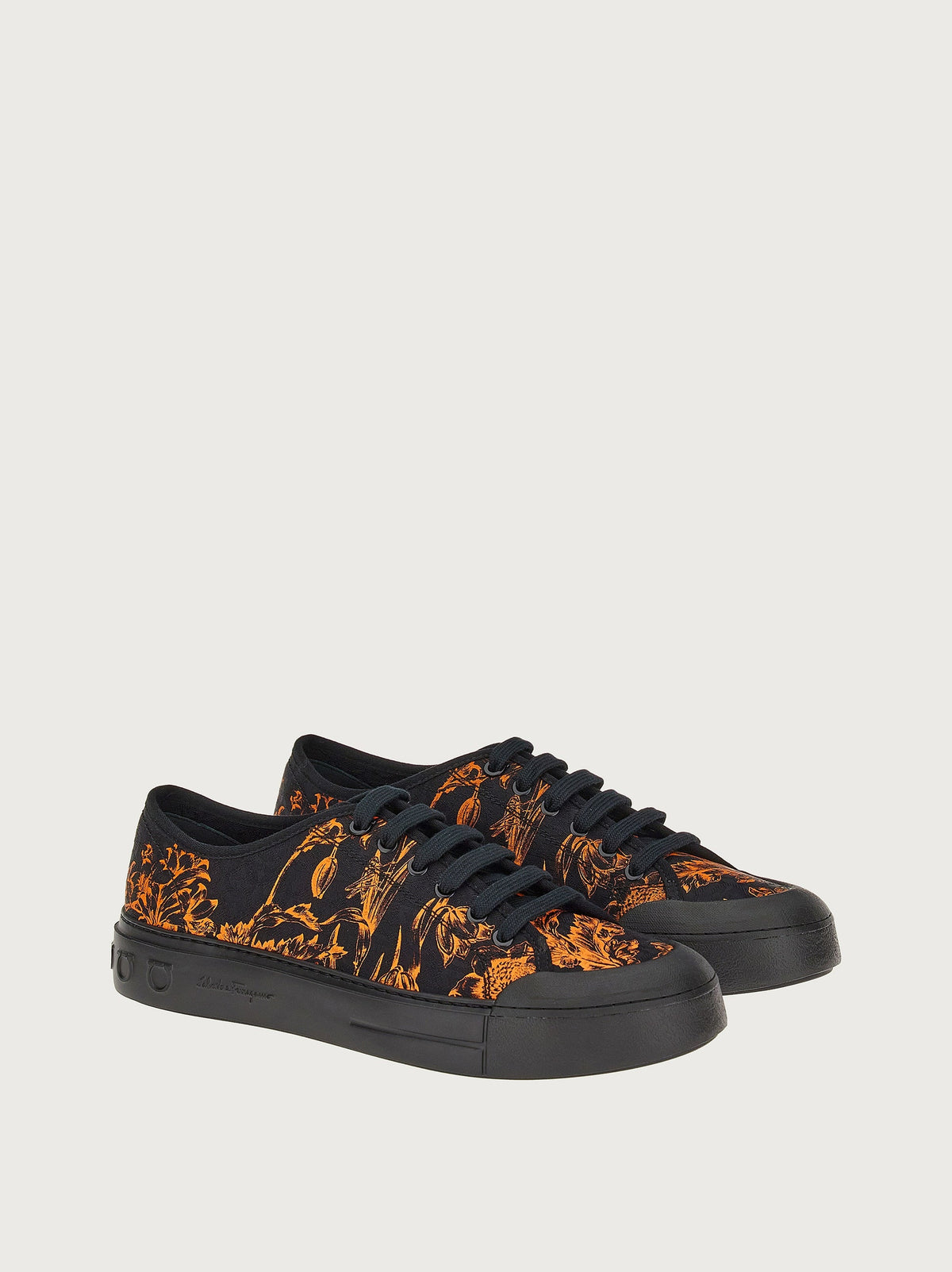 Black Salvatore Ferragamo sneaker with botanical print, front angle view