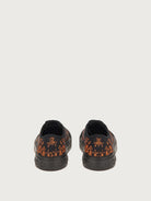 Salvatore Ferragamo canvas sneaker showing orange botanical print detail, top view