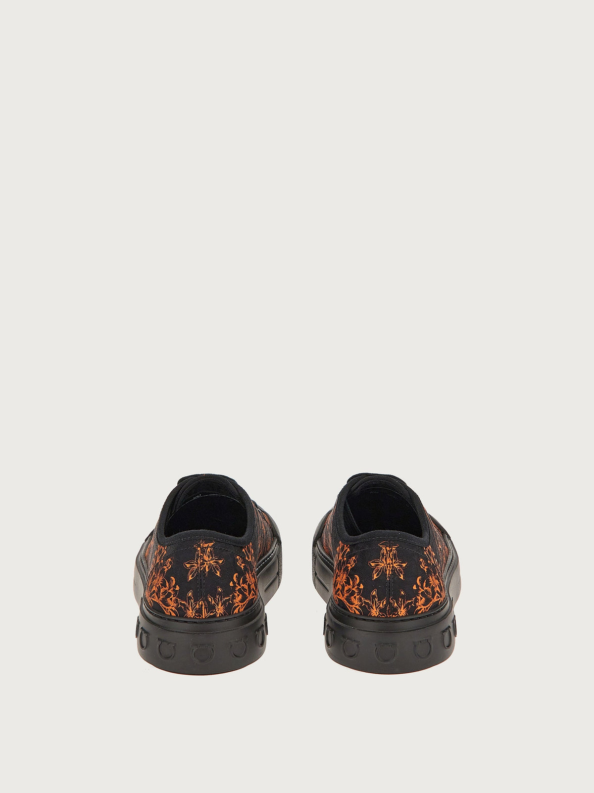 Salvatore Ferragamo canvas sneaker showing orange botanical print detail, top view