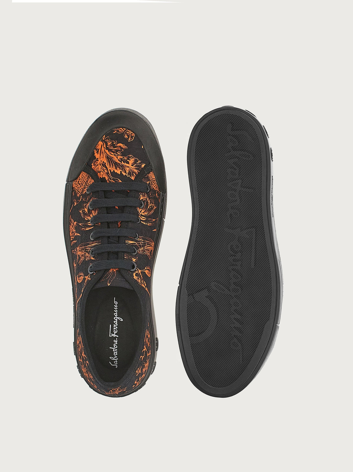 Black canvas sneaker by Salvatore Ferragamo showing lace-up closure and round toe