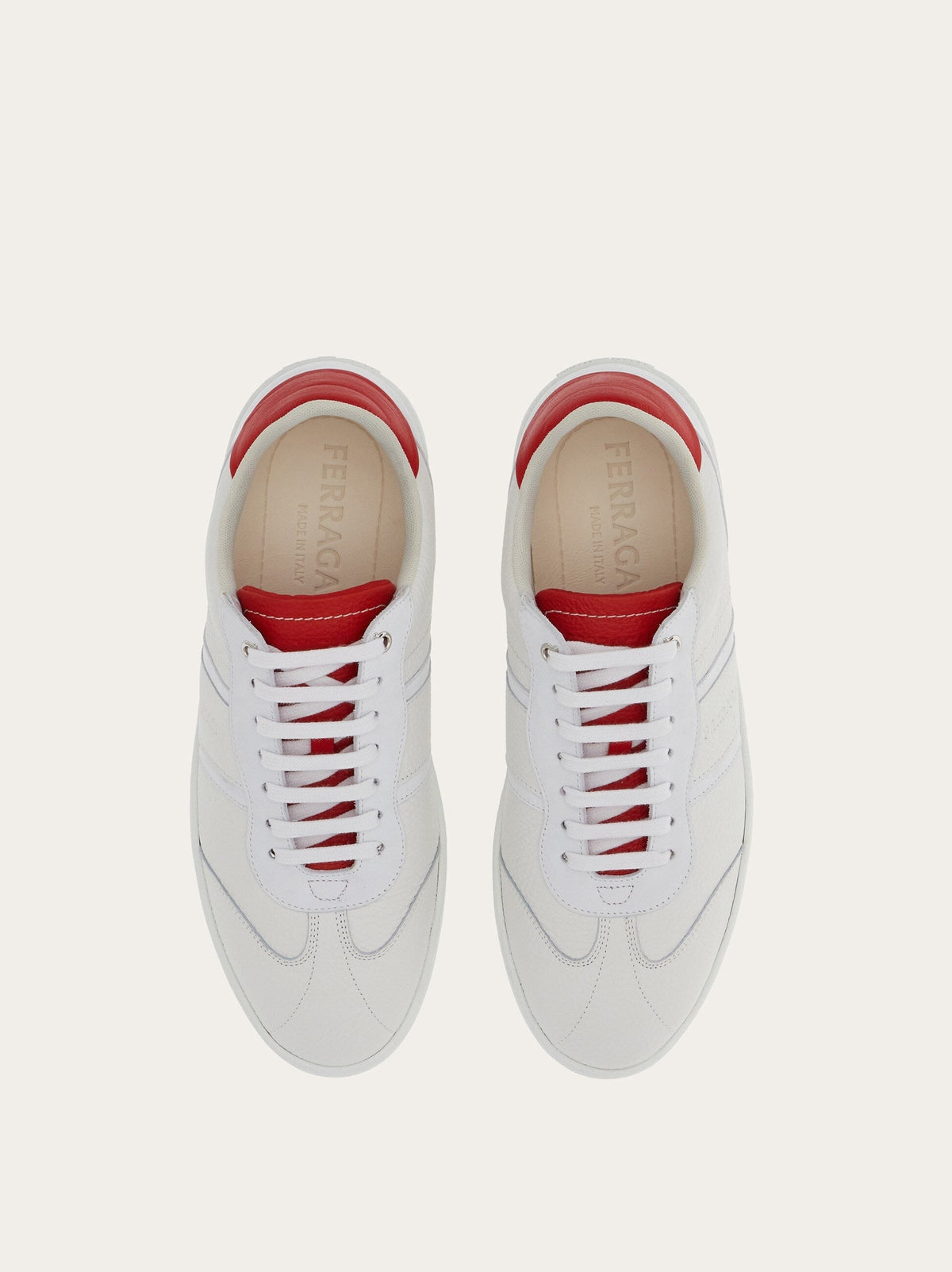White Salvatore Ferragamo leather sneaker with red accent, front angle view
