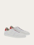 White calf leather sneaker by Salvatore Ferragamo with red heel tab, rear view