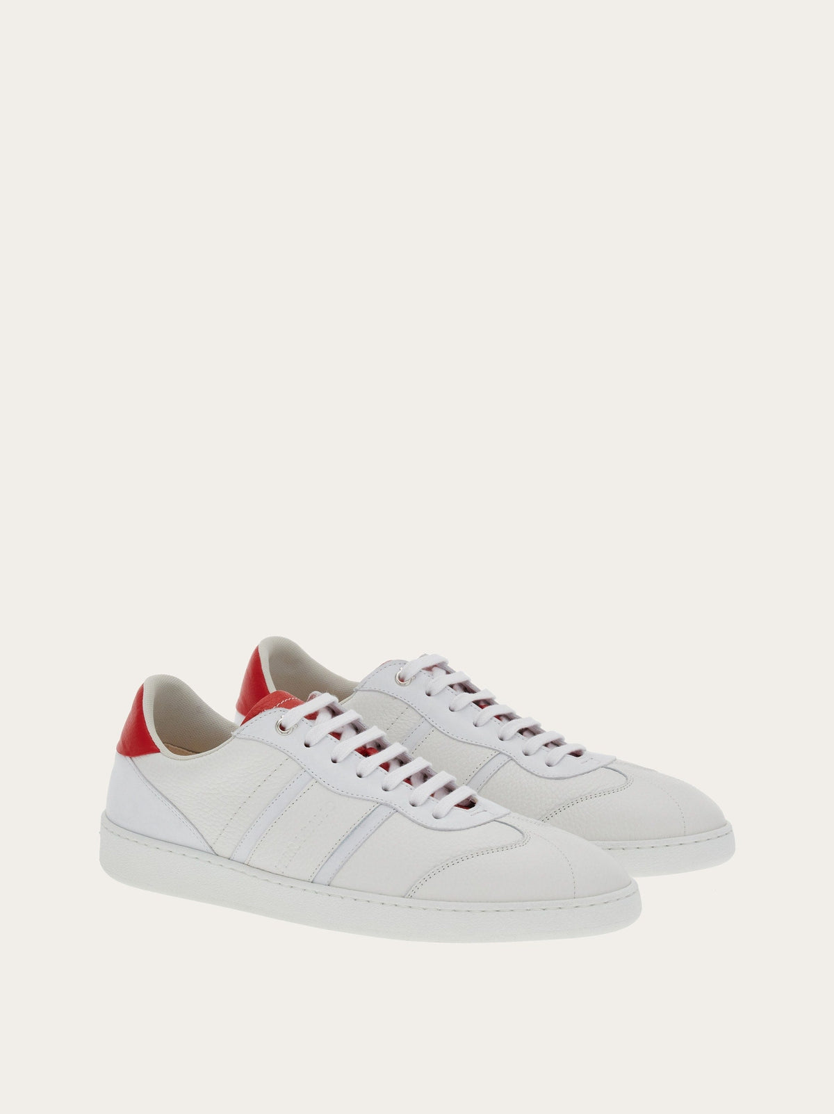 White calf leather sneaker by Salvatore Ferragamo with red heel tab, rear view
