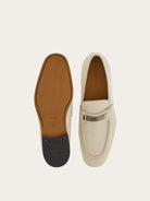 Close-up of silver-tone bit ornament on off-white leather moccasin by Salvatore Ferragamo
