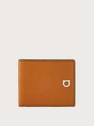 Tan leather bifold wallet with silver Gancini clasp by Salvatore Ferragamo, front view