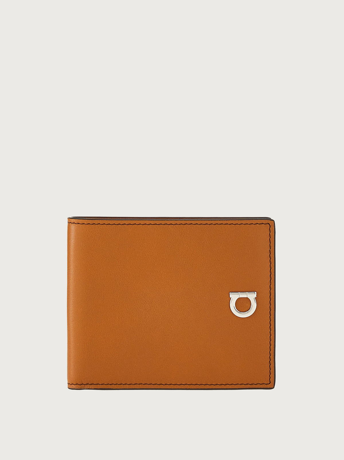 Tan leather bifold wallet with silver Gancini clasp by Salvatore Ferragamo, front view