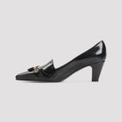 Black Celine pumps with gold-tone clamp and tassel detail, close-up