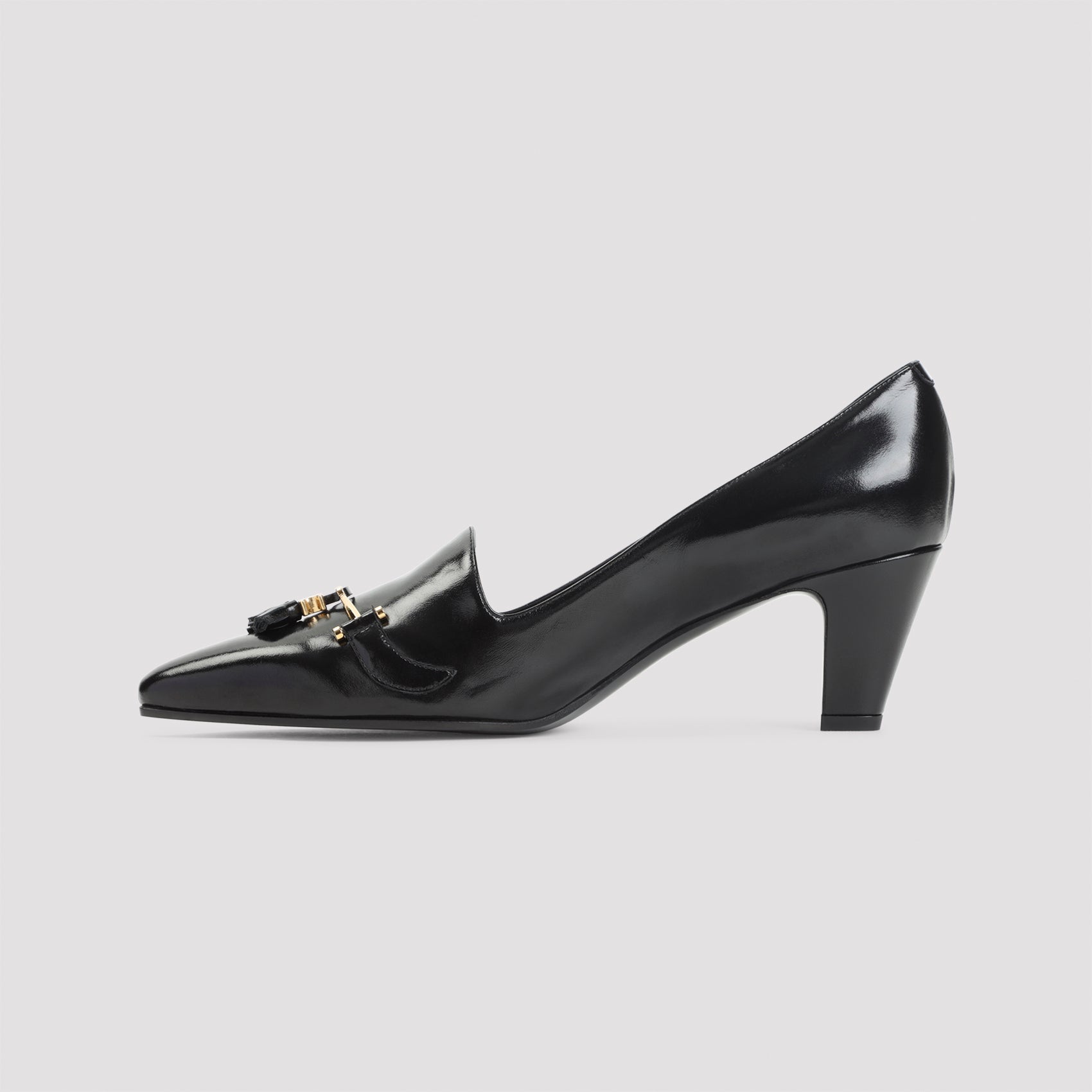 Black Celine pumps with gold-tone clamp and tassel detail, close-up