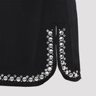 Black Rabanne mini skirt showing side slits and asymmetric hem detail