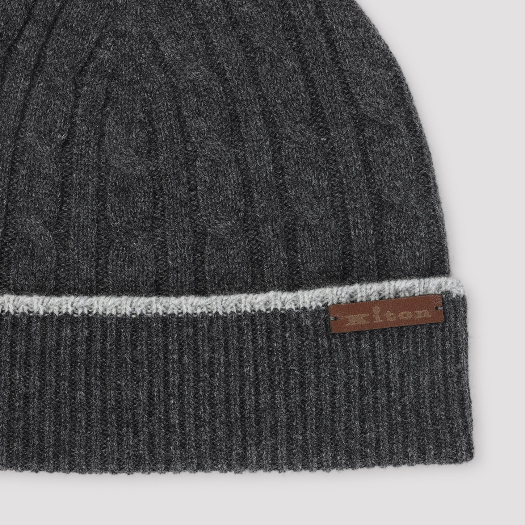 Dark grey Kiton cable-knit beanie showing logo detail and brim