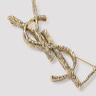 Golden-tone brass Monogramme brooch by Saint Laurent, side view