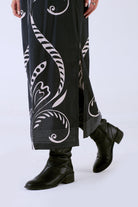 Beyond by Vera Fountain print skirt, detail view of side slit and embroidery