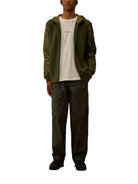 Green C.P. Company cargo trousers, side view showing pocket details
