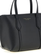 Black leather Perry handbag showing adjustable shoulder strap by Tory Burch
