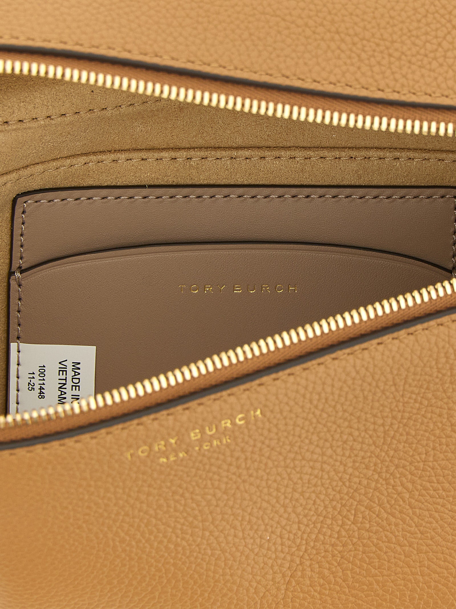Brown crossbody bag interior with microfiber lining by Tory Burch
