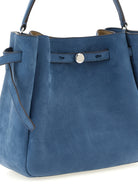 Blue nubuck Romy bucket bag showing top handle and shoulder strap, angled view